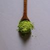matcha-powder-scoop matcha powder in a bamboo scoop